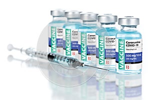 Coronavirus COVID-19 Vaccine Vials and Syringe On Reflective Surface