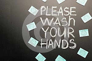 Coronavirus. Danger. Caring for cleanliness. Writing on blackboard. - Please wash your hands. With space for inscription or design