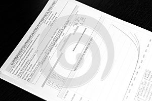 Coronavirus distribution research protocol 2019 nCoV. Information sheets of paper lie on a black surface.