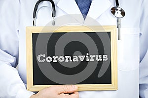 Coronavirus - doctor holding chalkboard with diagnosis