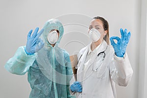 Coronavirus. Doctors are heroes. Wearing protective suits and masks. White background. Great team.