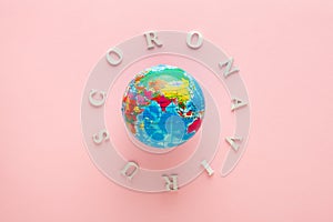 Coronavirus flu ncov and earth gloe isolated on pink background photo