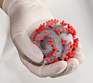 Coronavirus in gloved hand