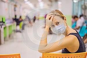 Coronavirus in the hospital covid 19. Woman in a medical mask Patients In Doctors Waiting Room