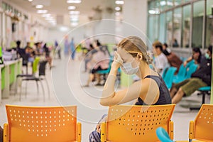 Coronavirus in the hospital covid 19. Woman in a medical mask Patients In Doctors Waiting Room