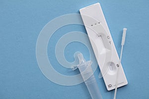 Coronavirus lateral flow home testing kit against a blue background