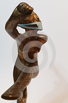 Coronavirus metaphore vintage brass statue dancer girl photo