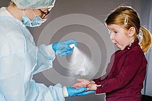 Coronavirus. Nurse, doctor in a protective suit, mask use sanitizer for kid. Preventive measures against Covid-19 infection. Ð