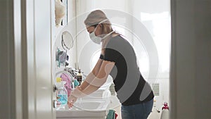 Coronavirus outbreak - woman wash hands with surgical mask