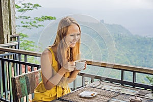 Coronavirus is over. Quarantine weakened. Take off the mask. Now you can go to public places. Young woman drinks coffee