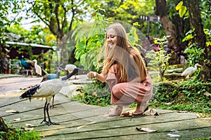 Coronavirus is over. Quarantine weakened. Take off the mask. Now you can go to public places. Young woman feeding an