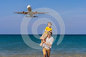 Coronavirus is over. Quarantine weakened. Take off the mask. Now you can travel. Dad and son have fun on the beach