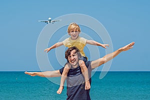 Coronavirus is over. Quarantine weakened. Take off the mask. Now you can travel. Father and son have fun on the beach