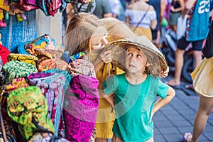 Coronavirus is over. Quarantine weakened. Take off the mask. Now you can travel. Mom and son travelers choose souvenirs