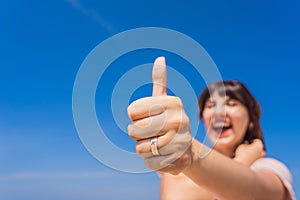 Coronavirus is over. Quarantine weakened. Take off the mask. Now you can travel. Woman shows a ring with an airplane