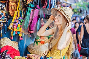 Coronavirus is over. Quarantine weakened. Take off the mask. Now you can travel. Woman traveler choose souvenirs in the