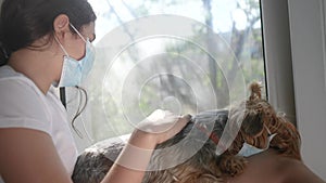 Coronavirus pandemic concept. little teenage girl puts medical mask on a dog. self-isolation virus concept covid 19