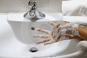 Coronavirus pandemic prevention wash hands with soap warm water