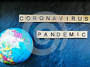 Coronavirus pandemic text with globe on blue background