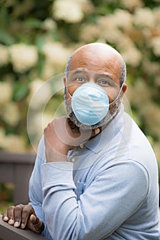 Coronavirus, portrait of African American man outside with protective mask.  Concept of Lockdown, Flatten the Curve, Social