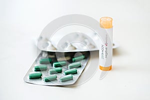 Coronavirus positive test sample and pills on a white backgorund. Coronavirus / healthcare concept.