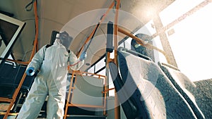 Coronavirus prevention, sanitary disinfection process. Inside view of a bus being chemically sanitised by a specialist