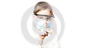 Coronavirus protection. The face of a child in a mask and glasses. A little preschool girl observes prevention of covid 19. Stay