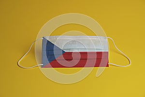 Coronavirus protective mask. Medical mask combined with the Czech Republic flag. yellow background. Face mask protection against
