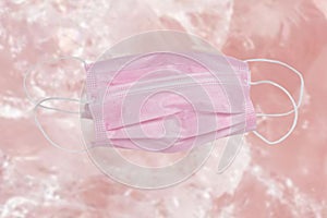 Coronavirus protective measures. Close-up of a pink surgical mask or medical face mask for protection from covid-19 virus on