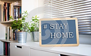 coronavirus quote stay home, save lives grey board sign with message of self isolation for social responsability on home