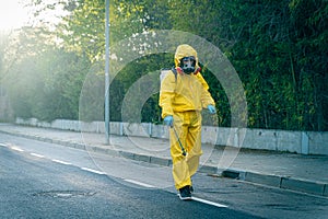 Coronavirus. A sanitation worker wearing a mask and cleaning the streets. Sterilize urban decontaminate city. Disinfecting against