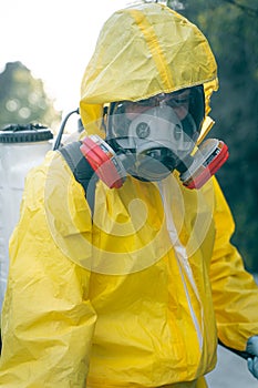 Coronavirus. A sanitation worker wearing a mask and cleaning the streets. Sterilize urban decontaminate city. Disinfecting against