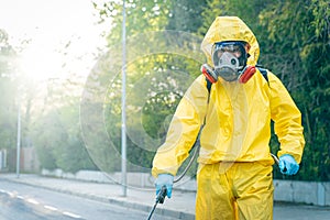 Coronavirus. A sanitation worker wearing a mask and cleaning the streets. Sterilize urban decontaminate city. Disinfecting against