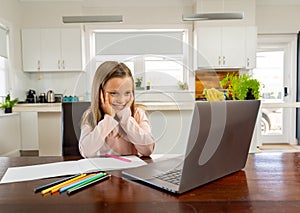 Coronavirus school closures and lockdown. Schoolgirl talking with teacher on a online class at home