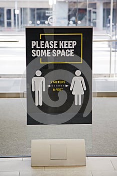 Coronavirus sign: Please Keep some space 2 meter between people.Information warning sign about