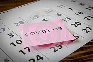 CORONAVIRUS. Sticker with the inscription COVID-19 on the calendar sheets. The concept of quarantine. Selective focus