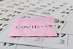 CORONAVIRUS. Sticker with the inscription COVID-19 on the calendar sheets. The concept of quarantine. Selective focus