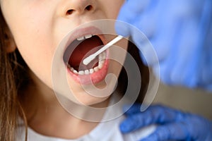 Coronavirus test and mouth, kid opens mouth for COVID-19 diagnostics