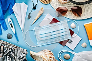 Coronavirus travel accessories on blue surface