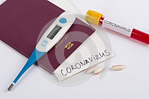 Coronavirus and travel concept. Note COVID-19 coronavirus, passport and mask. Corona virus outbreak, epidemic in Wuhan, China.