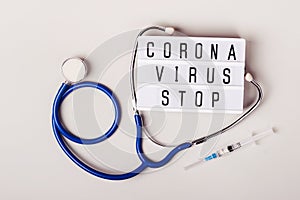 Coronavirus treatment concept. 2019-nCoV originating in Wuhan, China. Stethoscope and lightboard with words Coronavirus stop