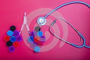 Model of lungs and stethoscope on red background.