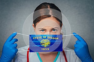 Coronavirus in U.S. State Oregon, Female Doctor Portrait, protect Face surgical medical mask with Oregon Flag. Illness, Virus