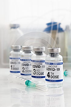 Coronavirus vaccine tagged first, second, Third and fourth dose of vaccine on the label