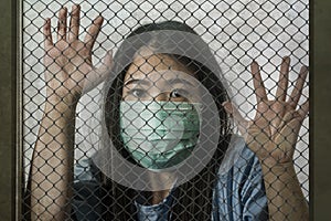 Coronavirus victim locked - young beautiful scared and sick Asian Chinese woman as patient in hospital ward infected with China