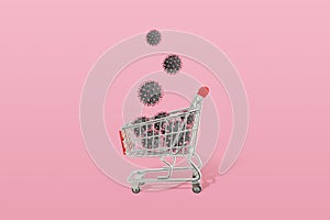 Coronavirus virions drop in shopping cart. Concept of season shopping and dangerous virus epidemic photo