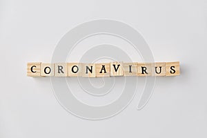 Coronavirus word on wooden toy blocks on white