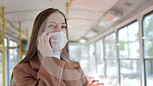 Coronavirus, young woman with mask traveling in the public transport by bus