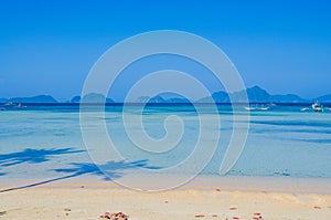 Corong corong beach. Seascape with island in ocean. Palm Shadows on the beach. El Nido, Palawan, Philippines