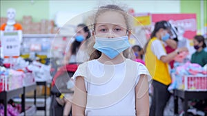 Corontin,people make quick purchases.Child in store in protective medical mask in a terrible epidemic of coronavirus or